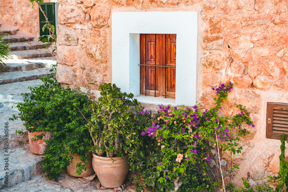 Naklejka premium View of a medieval street in the Old Town of the picturesque Spanish-style village Fornalutx, Majorca or Mallorca island