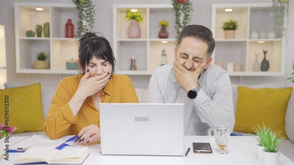 Couple falling asleep while working on laptop. Exhausting work. Couple falling asleep while working on laptop. Exhausting work.