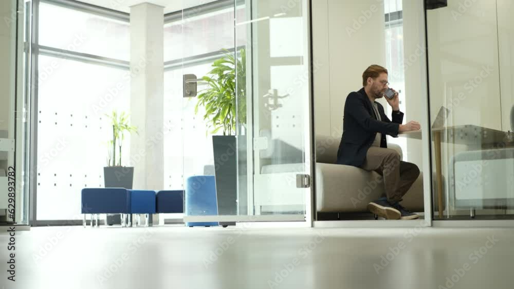 Focused businessman working in an office in a silent room with laptop Focused businessman working in an office in a silent room with laptop