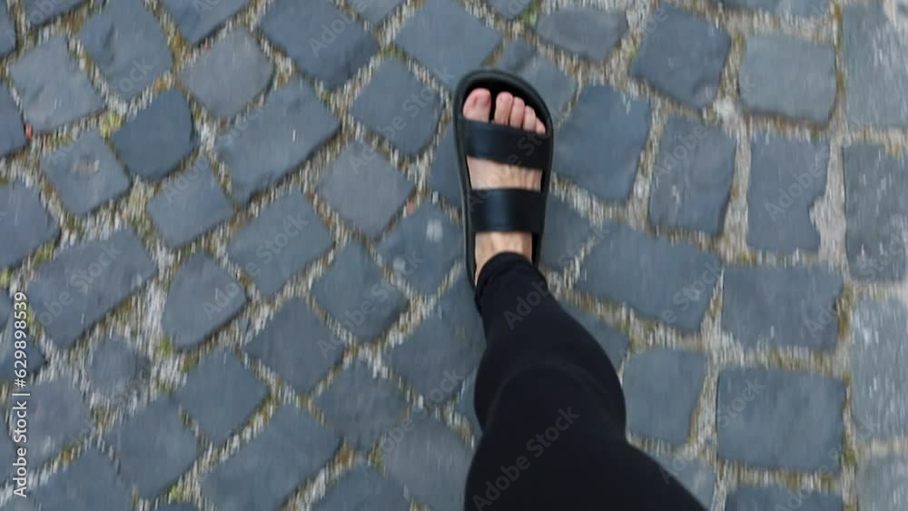 Girl takes pictures of her feet walking on the pavement Girl takes pictures of her feet walking on the pavement