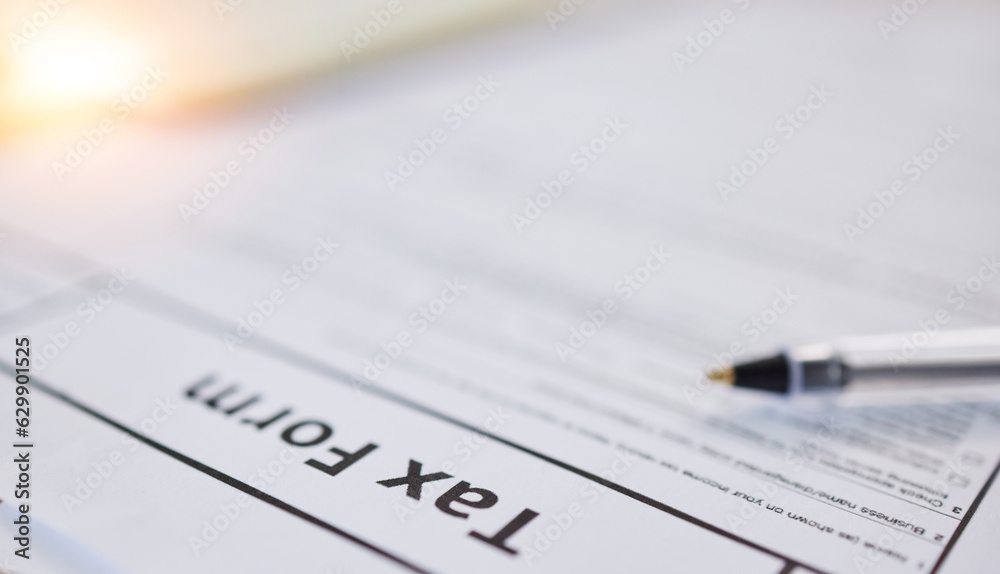 Taxes paperwork, closeup and finance with accounting, form for income information, audit and contract. Financial paper, money and tax return, government documents and salary earnings with revenue Taxes paperwork, closeup and finance with accounting, form for income information, audit and contract. Financial paper, money and tax return, government documents and salary earnings with revenue