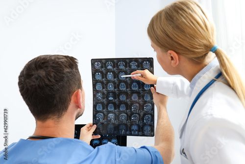 Doctors look at MRI images of a human head