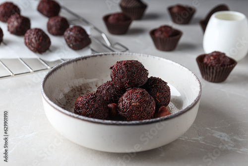 Brigadeiro in white bowl on marble background, close up