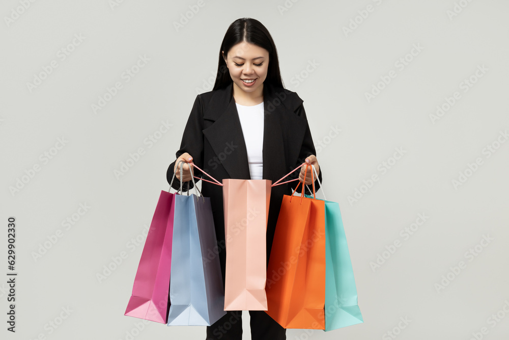 Girl of Asian appearance with paper bags for shopping