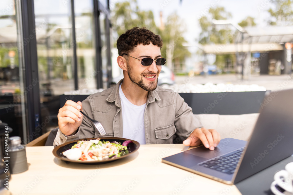 Young man having a salad for lunch, healthy eating. Young man having a salad for lunch, healthy eating.