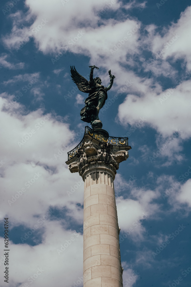 Fotografía en vertical del Monument aux Girondins en Burdeos, Francia, con el cielo con nubes detrás.