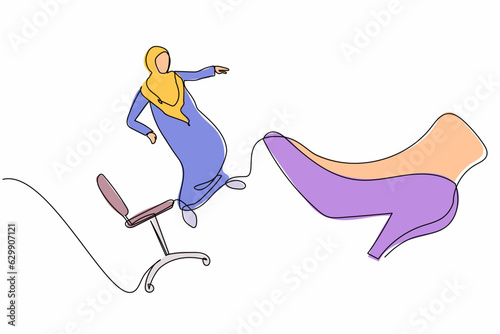 Single one line drawing unhappy small Arabian businesswoman kicked out by big foot from chair. Staff reduction, fired worker. Minimal metaphor. Continuous line draw design graphic vector illustration