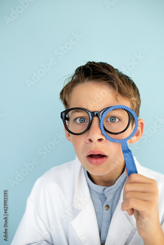 young mad scientist boy with white coat and blue ring