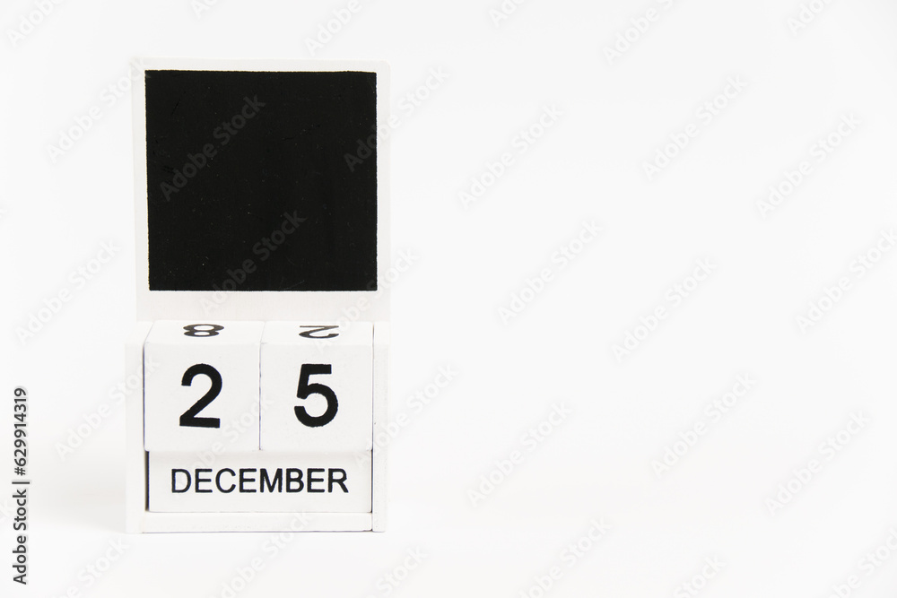Wooden calendar with the date December 25 on a white background. The concept of preparing for the Christmas and New Year holidays. Wooden calendar with the date December 25 on a white background. The concept of preparing for the Christmas and New Year holidays.