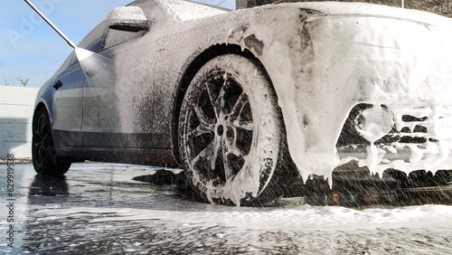 Wallpaper Mural Washing luxury car on a touchless car wash. Washing sedan car with foam and a high pressure water. Spring cleaning in a car wash. Torontodigital.ca