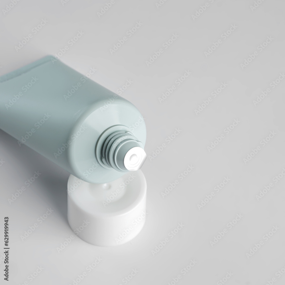 close up of open plastic aqueeze tube with cream, toothpaste, lotion or medicine on white background. New package before use. Cosmetics mockup close up of open plastic aqueeze tube with cream, toothpaste, lotion or medicine on white background. New package before use. Cosmetics mockup