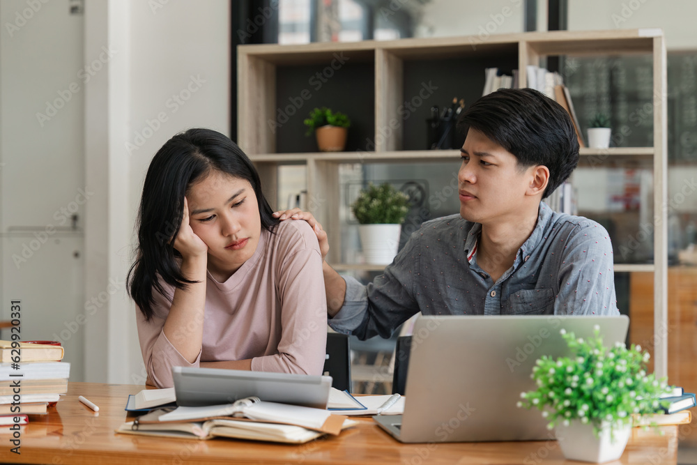 Caring Asian male students is comforting female students and showing support to upset and stressed out Caring Asian male students is comforting female students and showing support to upset and stressed out