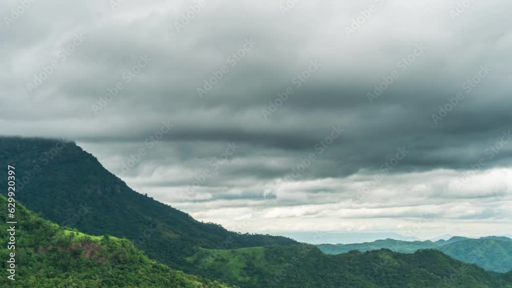 Time lapse of rain clouds wave rapidly over the densely forested mountains before the rain. Time lapse of rain clouds wave rapidly over the densely forested mountains before the rain.