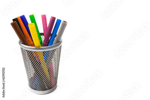 Colored felt tip pens in a pencil holder, isolated on white background.