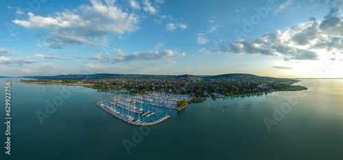 Fototapeta Naklejka Na Ścianę i Meble -  Panoramic aerial view about the pier of Alsoors town in lake Balaton in Hungary. This place is a part of the north coast of the Hungarian sea. There are many luxury yacht in the harbor.