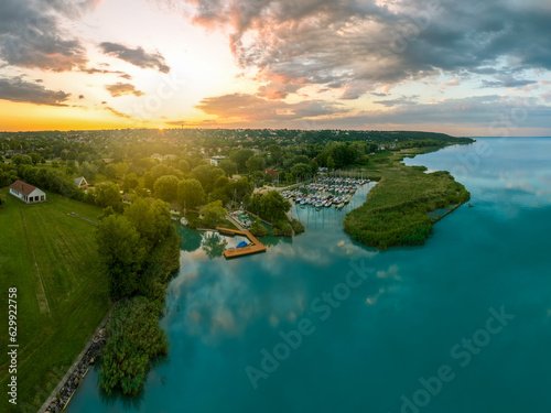 Aerial view about the north end  of lake Balaton in Hungary. This place is at Balatonfuzfo town. There is a small yacht harbor and fantastic sunrise light on the background. photo