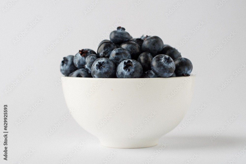 bowl with blueberries on a white background, close, horizontal, macro. bowl with blueberries on a white background, close, horizontal, macro.