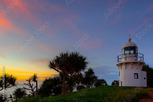 Colourful sunrise sky and pandanus trees at Fingal Head lighthouse  NSW