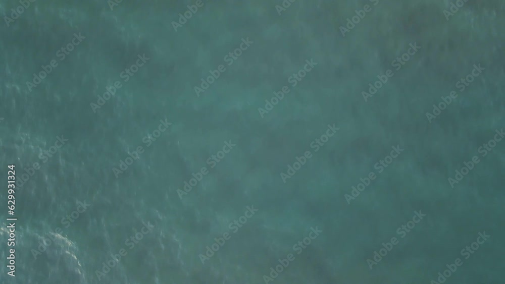 Aerial view of waves breaking along the shoreline on the beach in Capaccio, Paestum, Campania, Italy. Aerial view of waves breaking along the shoreline on the beach in Capaccio, Paestum, Campania, Italy.