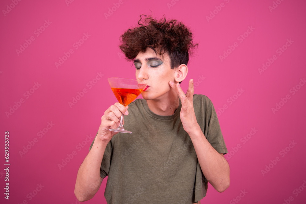 lgbt culture. Funny Drag Queen at the party drinking a cocktail. Pink background. lgbt culture. Funny Drag Queen at the party drinking a cocktail. Pink background.