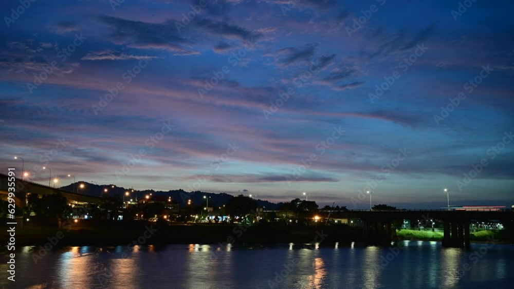 Street lights and car lights flow and reflect on the lake. Romantic night scene. Appreciate the summer Milky Way starry sky in Bitan, New Taipei City. Street lights and car lights flow and reflect on the lake. Romantic night scene. Appreciate the summer Milky Way starry sky in Bitan, New Taipei City.