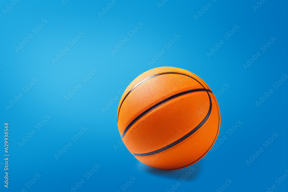 Bright orange basketball, isolated on a blue background with copy space