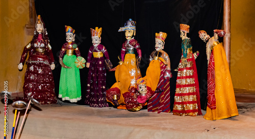 Night photography of a puppet show with various characters wearing traditional dresses.