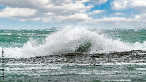 Big waves crash on the coastal rocks