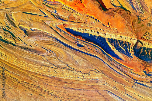 Fototapeta Naklejka Na Ścianę i Meble -  Terrain of the Bighorn Basin in between Wyoming and Montana, USA. The Sheep Mountain Anticline to the right in the scene. Digital enhancement of an image furnished by NASA