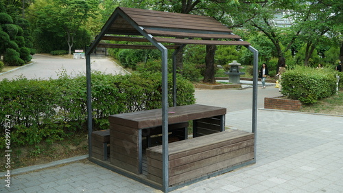 Wooden shelter with roof and table in outdoor park