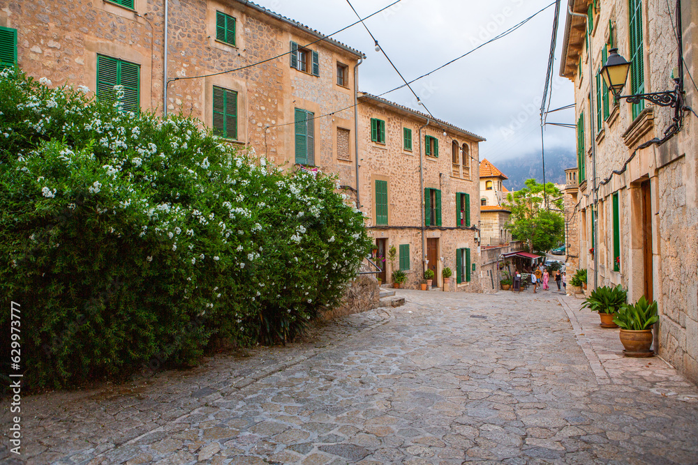 View of a medieval street of the picturesque Spanish-style village Valdemossa in Majorca or Mallorca island, Spain.