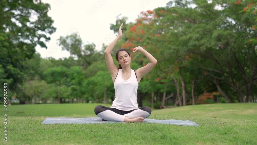 Asian attractive young woman have a beautiful body, Playing yoga in an elegant posture, in the green park, concept to people recreation and health care concept. Asian attractive young woman have a beautiful body, Playing yoga in an elegant posture, in the green park, concept to people recreation and health care concept.