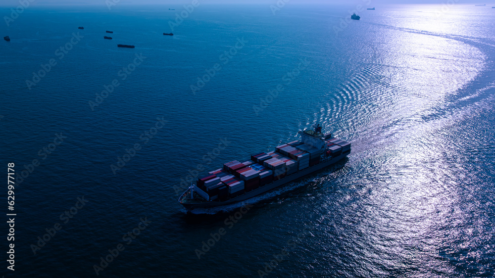 night process blue tone of cargo container ship sailing full speed in sea to import export goods and distributing products to dealer and consumers worldwide, by container ship Transport business night process blue tone of cargo container ship sailing full speed in sea to import export goods and distributing products to dealer and consumers worldwide, by container ship Transport business