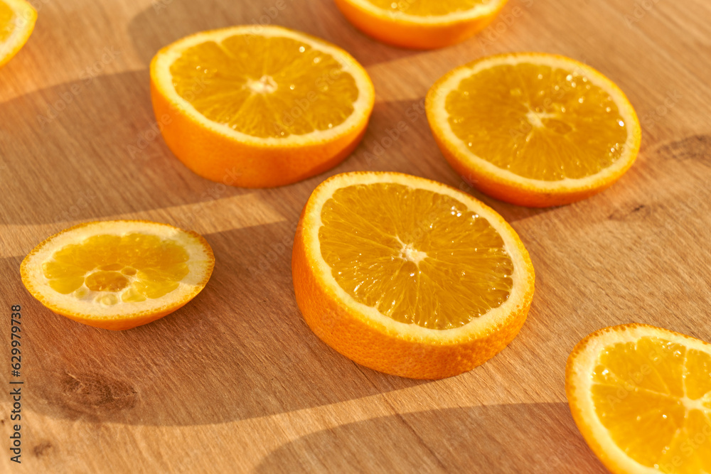 Slices of fresh organic oranges on a wooden kitchen table. Slices of fresh organic oranges on a wooden kitchen table.
