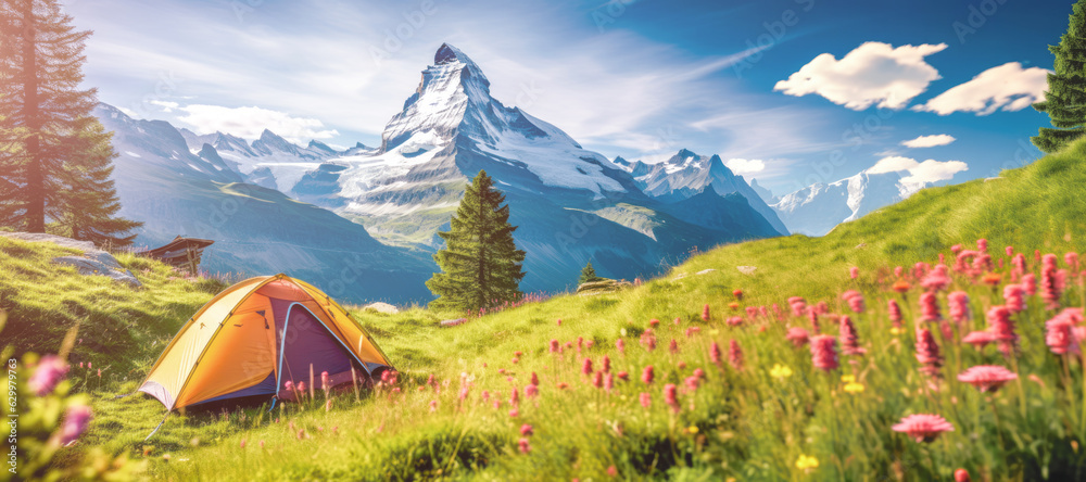 A camping tent on a meadow in Alps with majestic Matternhorn in the background.