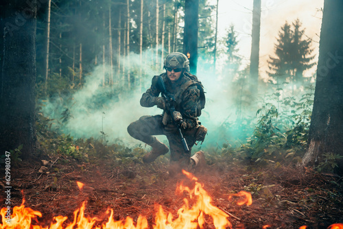 Modern warfare soldier surrounded by fire, fight in dense and dangerous forest areas