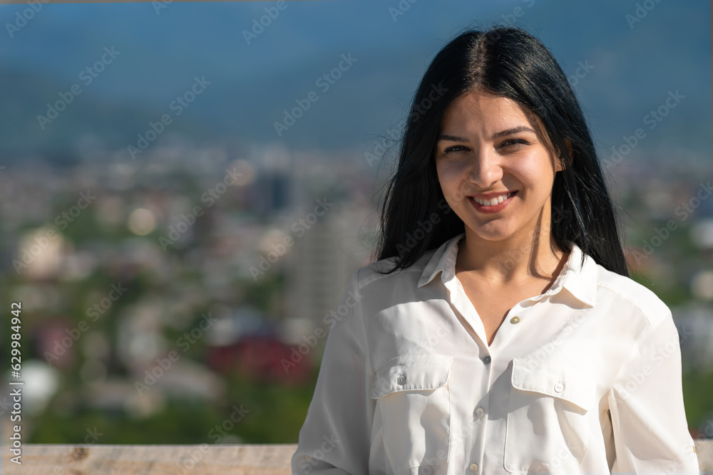 Portrait of a young happy smiling woman in business clothes at a construction site on a sunny day Portrait of a young happy smiling woman in business clothes at a construction site on a sunny day
