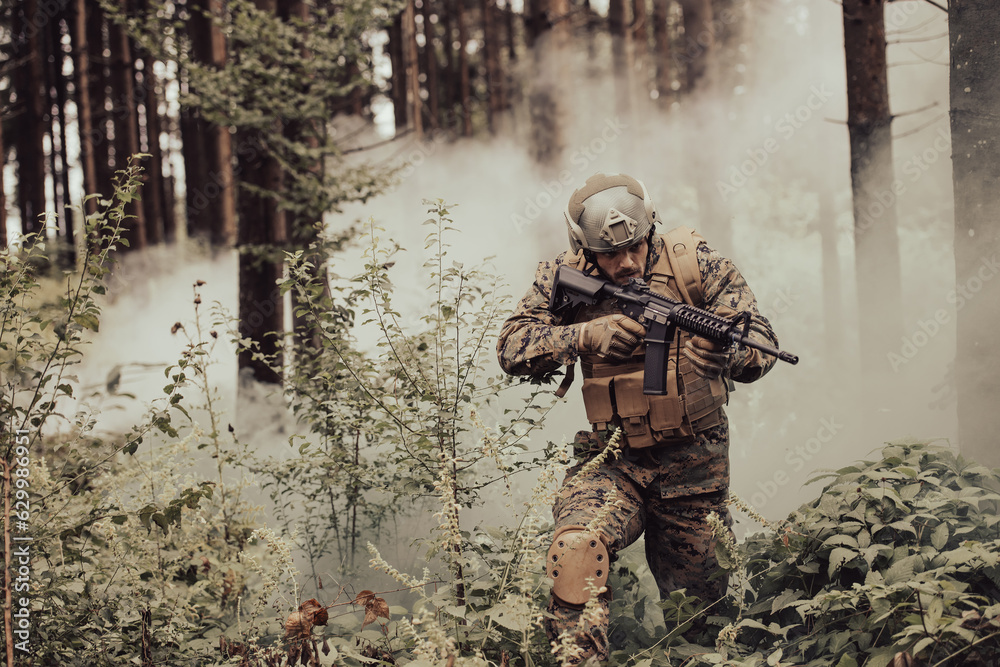 Fototapeta premium A modern warfare soldier on war duty in dense and dangerous forest areas. Dangerous military rescue operations