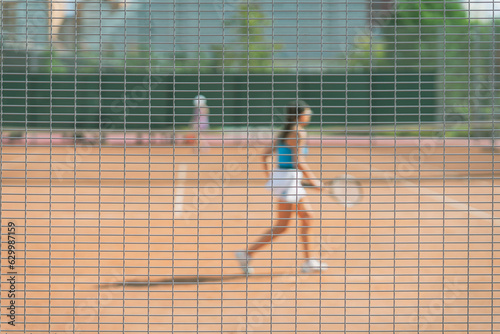 Abstract blurred background, girl playing tennis outdoors. Concept of sport © svetlanais