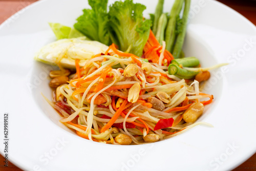 Spicy papaya salad in white plate