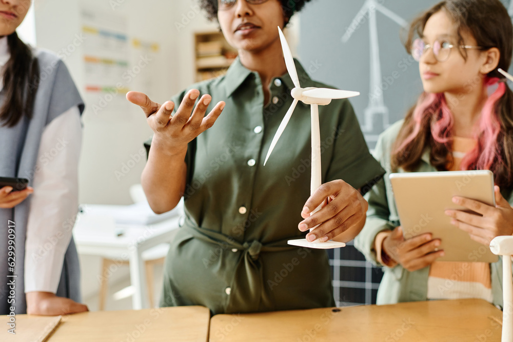African American teacher talking about windmill to students at lesson African American teacher talking about windmill to students at lesson