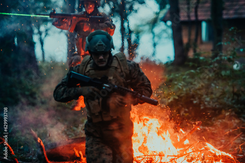 Soldier in Action at Night in the Forest Area. Night Time Military Mission jumping over fire