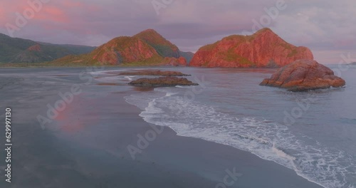 Aerial: Calm ocean beach at sunset. Whatipu, Auckland photo