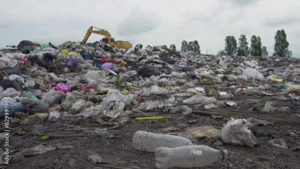 man wearing black gloves picks up plastic bottles for recycling. man wearing black gloves picks up plastic bottles for recycling.
