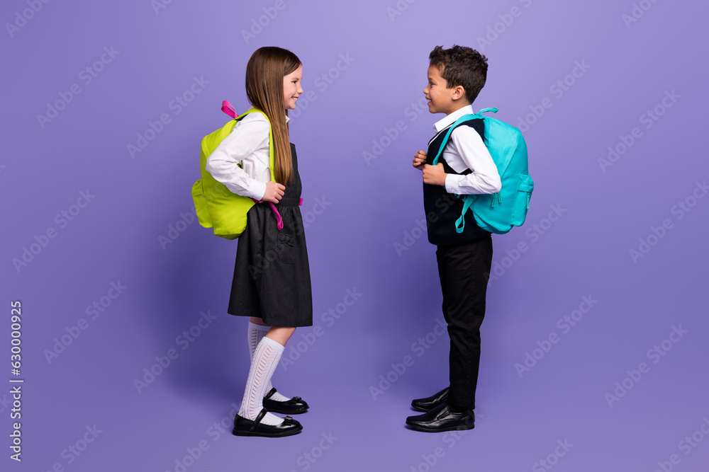 Fototapeta premium Photot of two kids pupils best friends meeting after summer holidays start new school year isolated bright color background