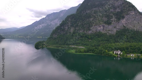 Stunning Austrian mountains from a bird's-eye view. Fascinating blue lake, green mountain forests. Mountain towns. Roads for travel.