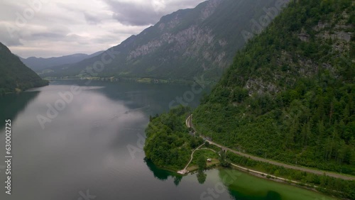 Stunning Austrian mountains from a bird's-eye view. Fascinating blue lake, green mountain forests. Mountain towns. Roads for travel.