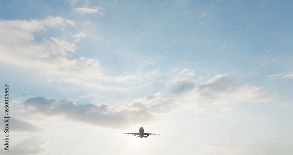 Fototapeta premium Airplane in the sky at sunset. Air transportation. Travel. Airplane Takes Off Against the Background of Blue Sky. 