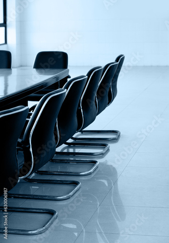 Conference table and chairs in empty meeting room photo