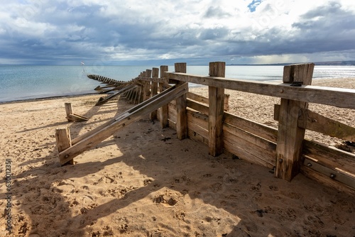 Close-up shot of a wooden fence on a beach in Portobello, Edinburgh, United Kingdom © Sam Lawrence/Wirestock Creators